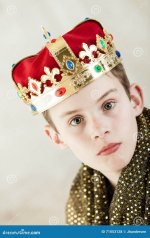 serious-young-boy-royal-gown-crown-tilt-angle-view-single-large-sparkling-gold-robe-wide-brim-...jpg