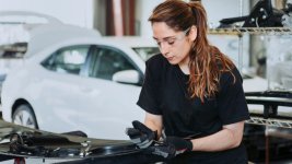 female-technician-fixing-car-parts-garage.jpg