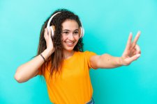 young-arab-woman-isolated-blue-background-listening-music-singing.jpg