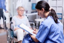 nurse-writing-prescription-disabled-senior-woman-wheelchair-after-medical-examination.jpg